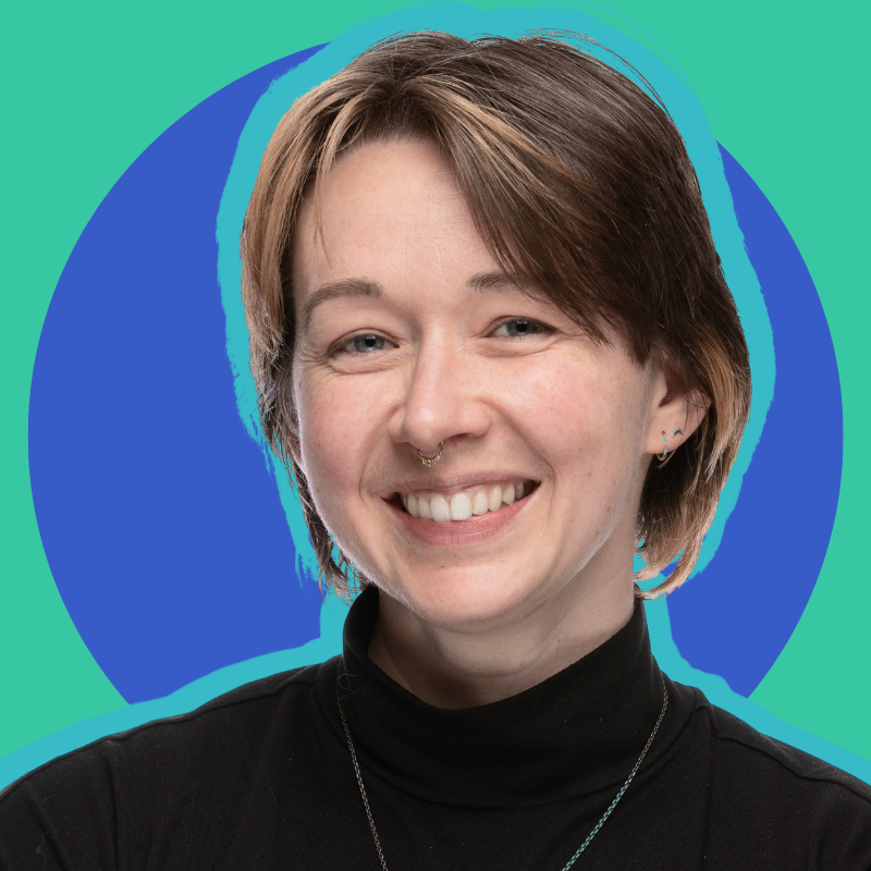 Headshot of Gardner smiling at the camera with different shades of blue in the background